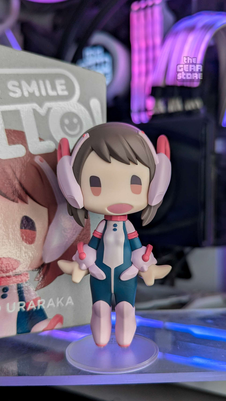An Uraraka Ochaco figure on The GEAR Store's desk, the RGB-lit PC behind it
