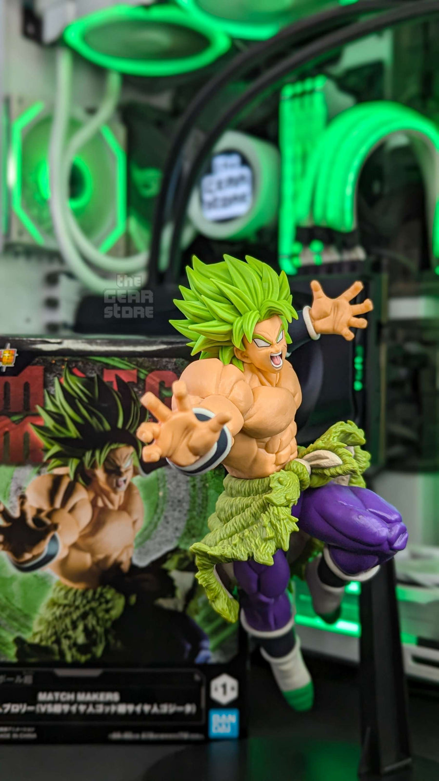 A Broly figure mid-transformation on The GEAR Store's desk, the RGB-lit PC behind it