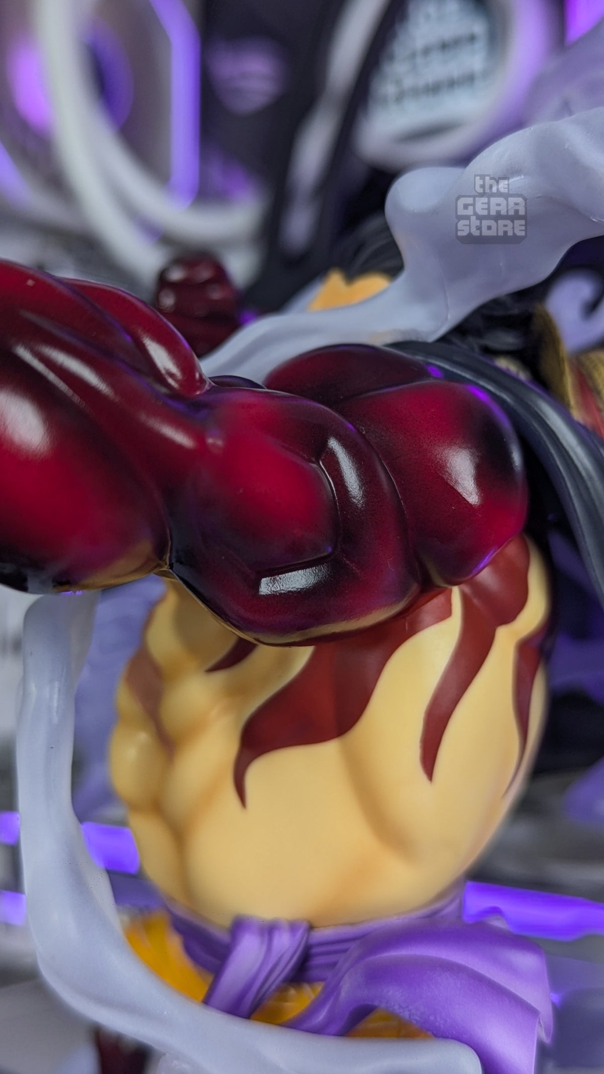 Luffy's Haki-coated forearm and fist over his inflated torso with flame-pattern markings