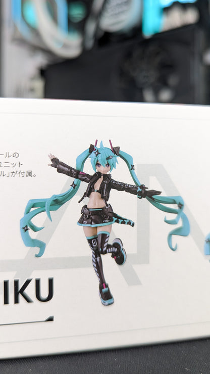 The built PLAMATEA Miku kit posed with arms spread, showing the tactical skirt, thigh-highs and boots