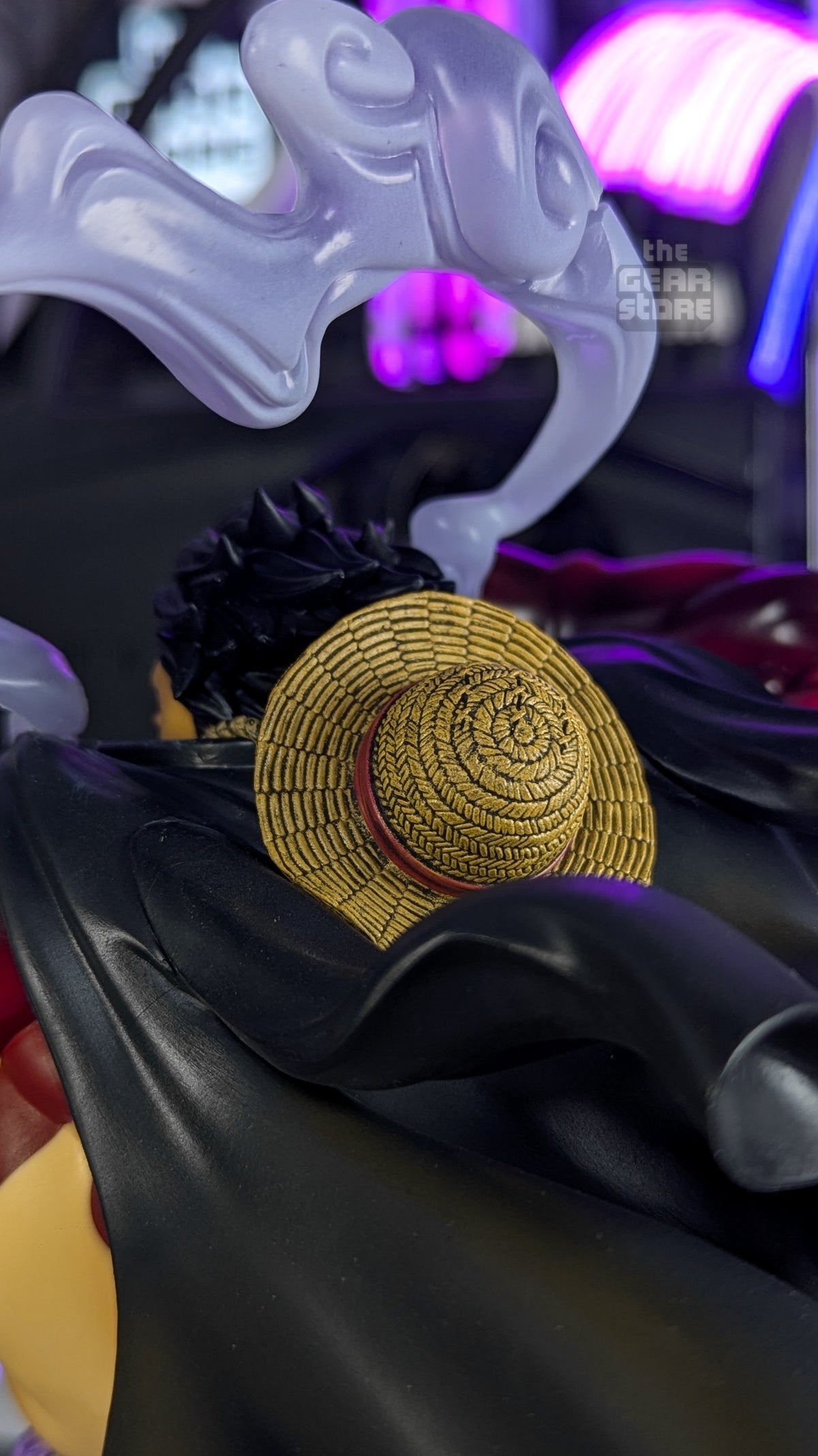 Close-up of the sculpted straw hat hanging on the back of Luffy's black coat