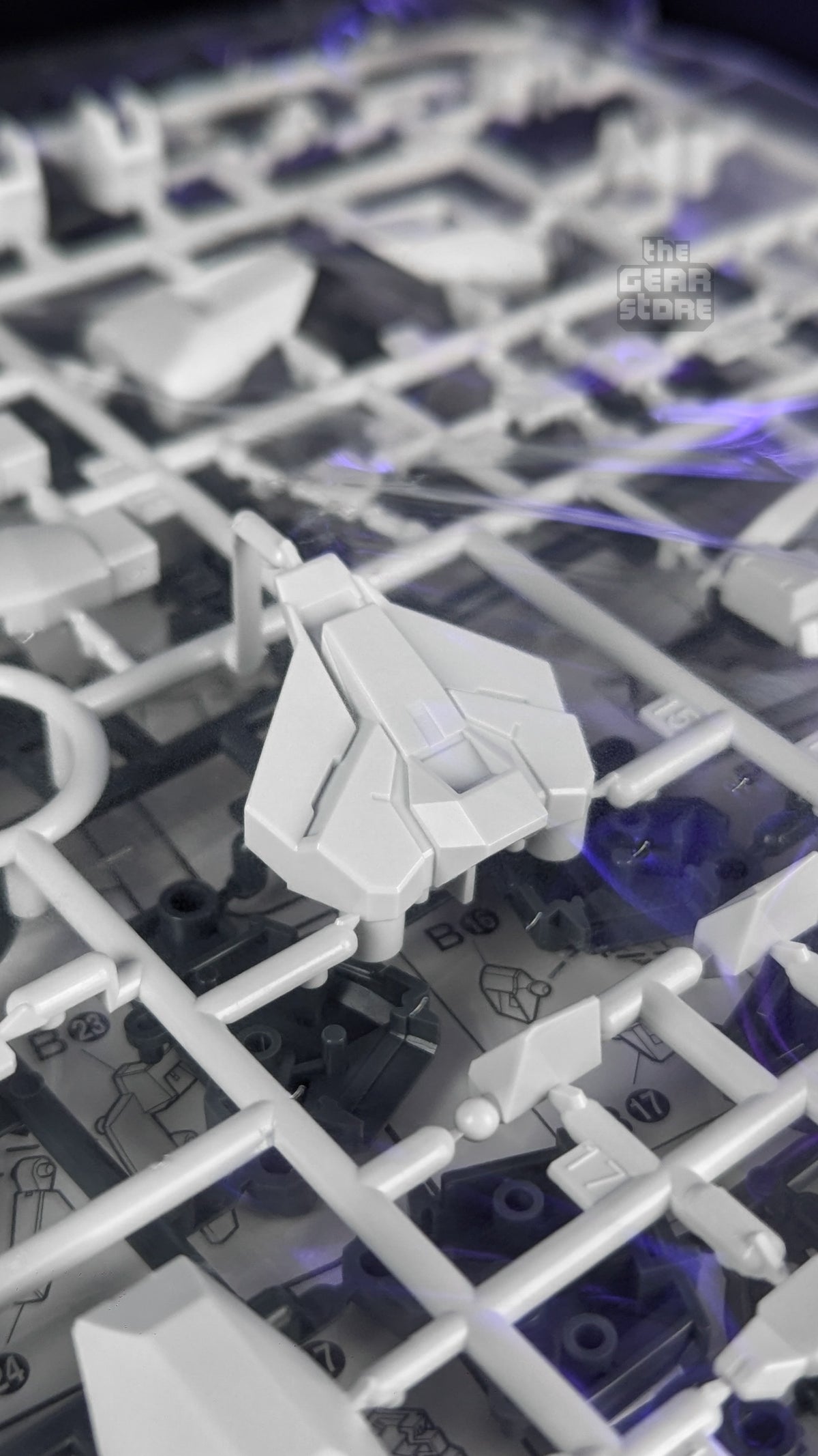 Sealed runners of white and grey parts inside the Gundam AGE-FX kit box