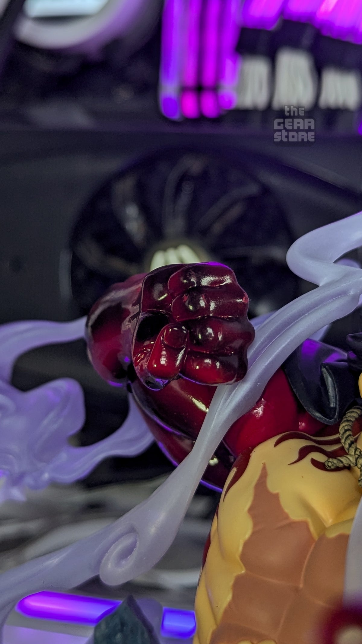 Close-up of Luffy's raised Haki-coated fist, painted in glossy dark red
