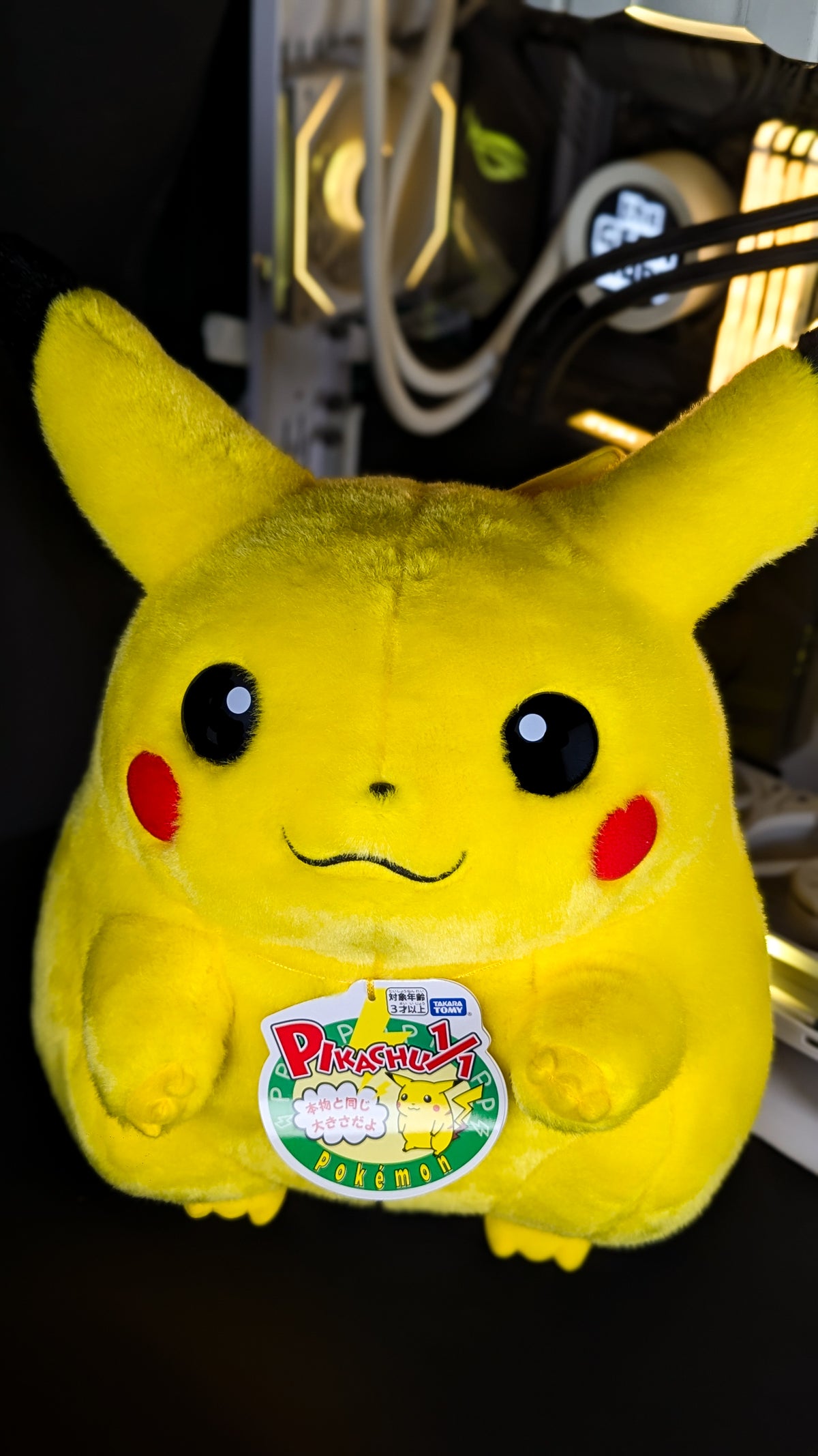 Takara Tomy Welcome Back! Pikachu 1/1 life-size plush seen head-on, showing the rounded body, red cheek patches and both feet