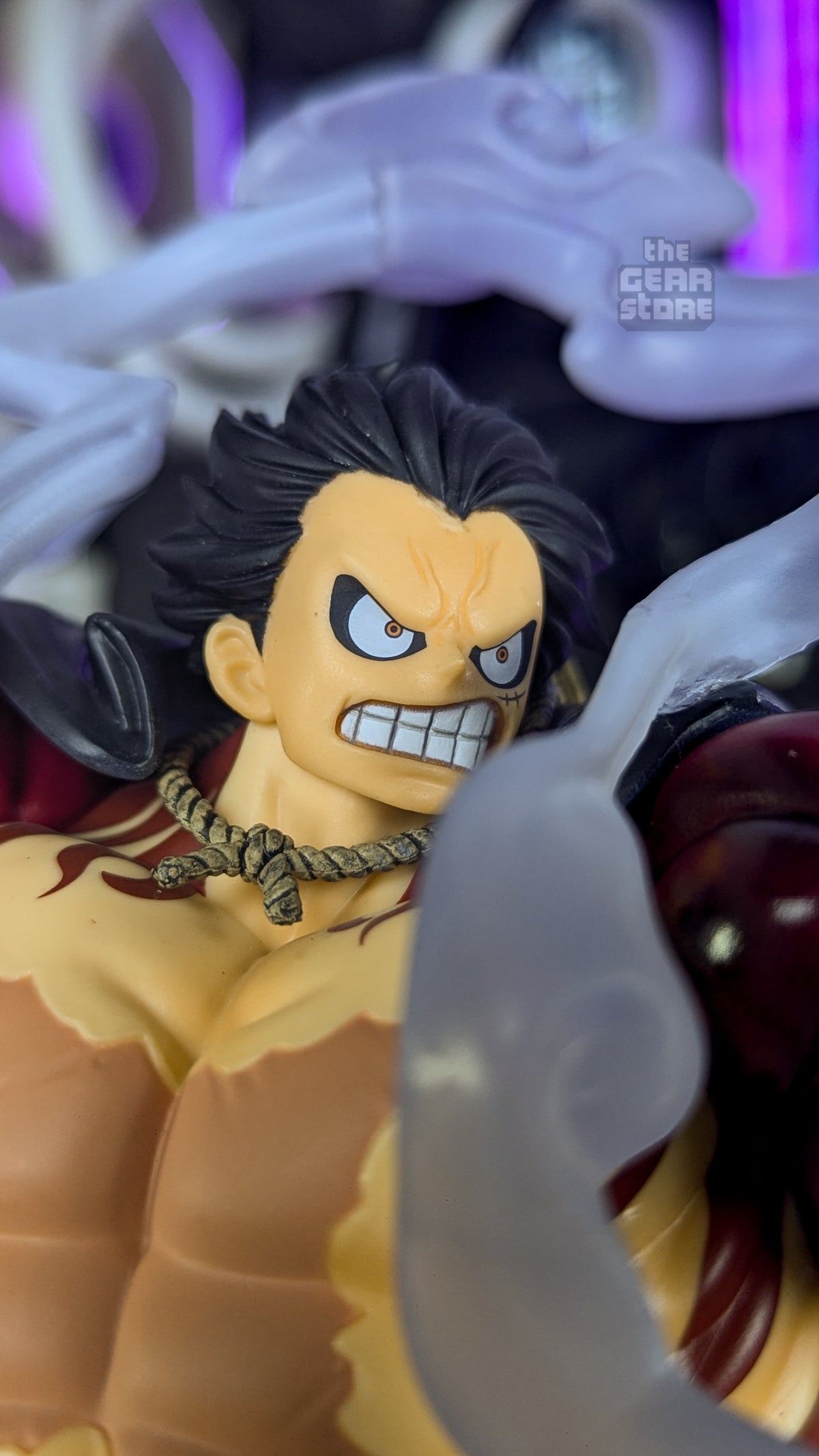 Close-up of Gear 4 Luffy's face, gritting his teeth with a furious expression