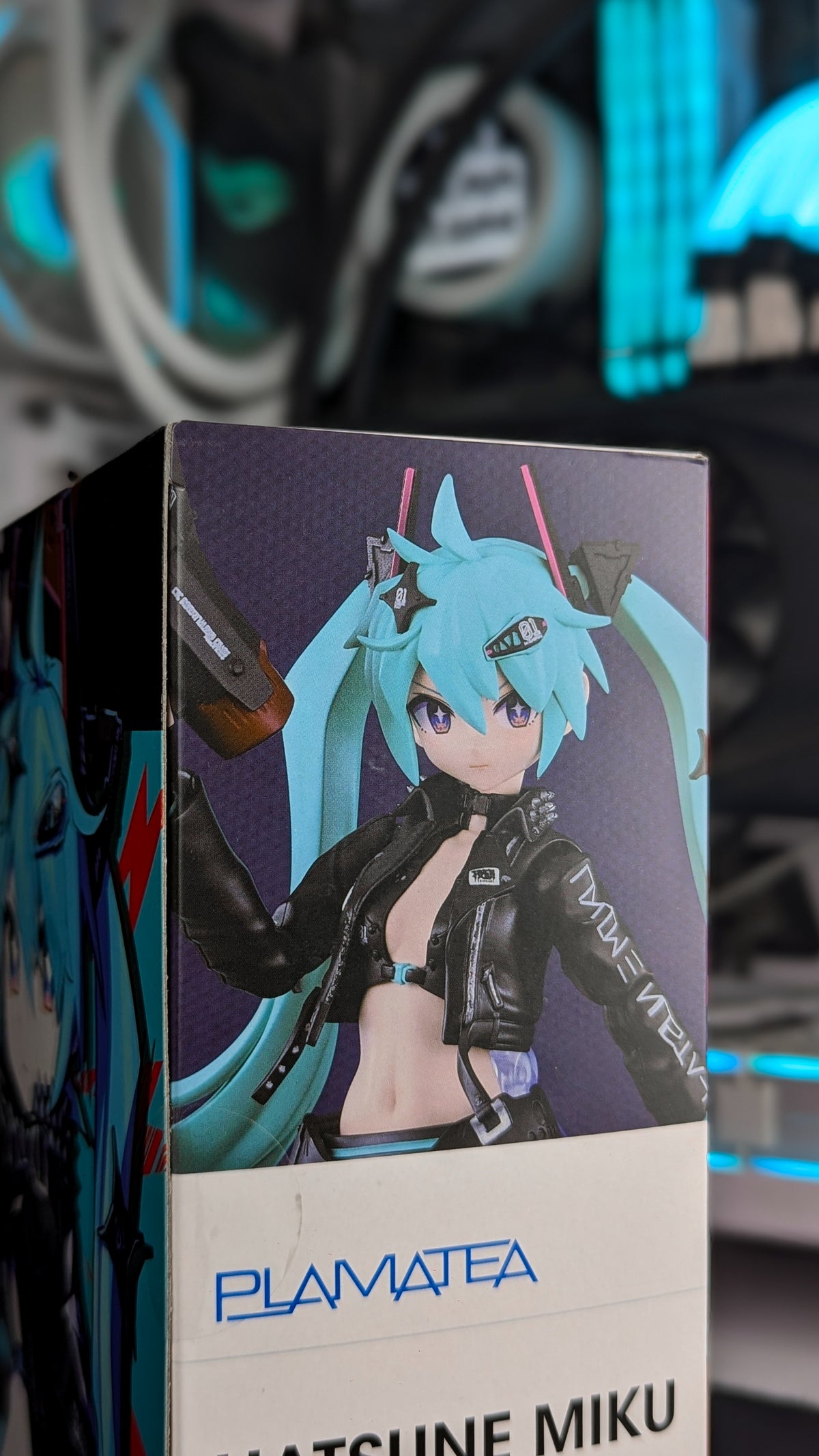 Close-up of the built PLAMATEA Miku kit showing the studded leather jacket, armoured arm and twintail clips